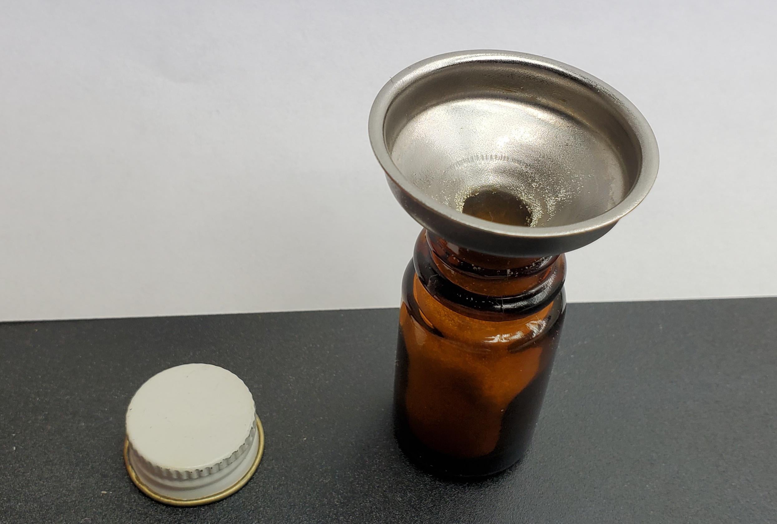 A mini funnel will really help in loading up your bottle without loosing crystals